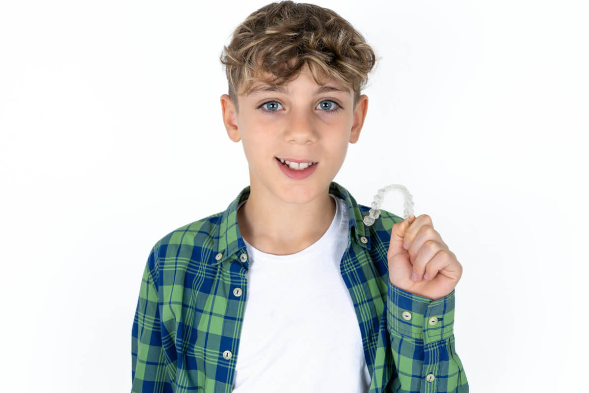 child holding clear aligners